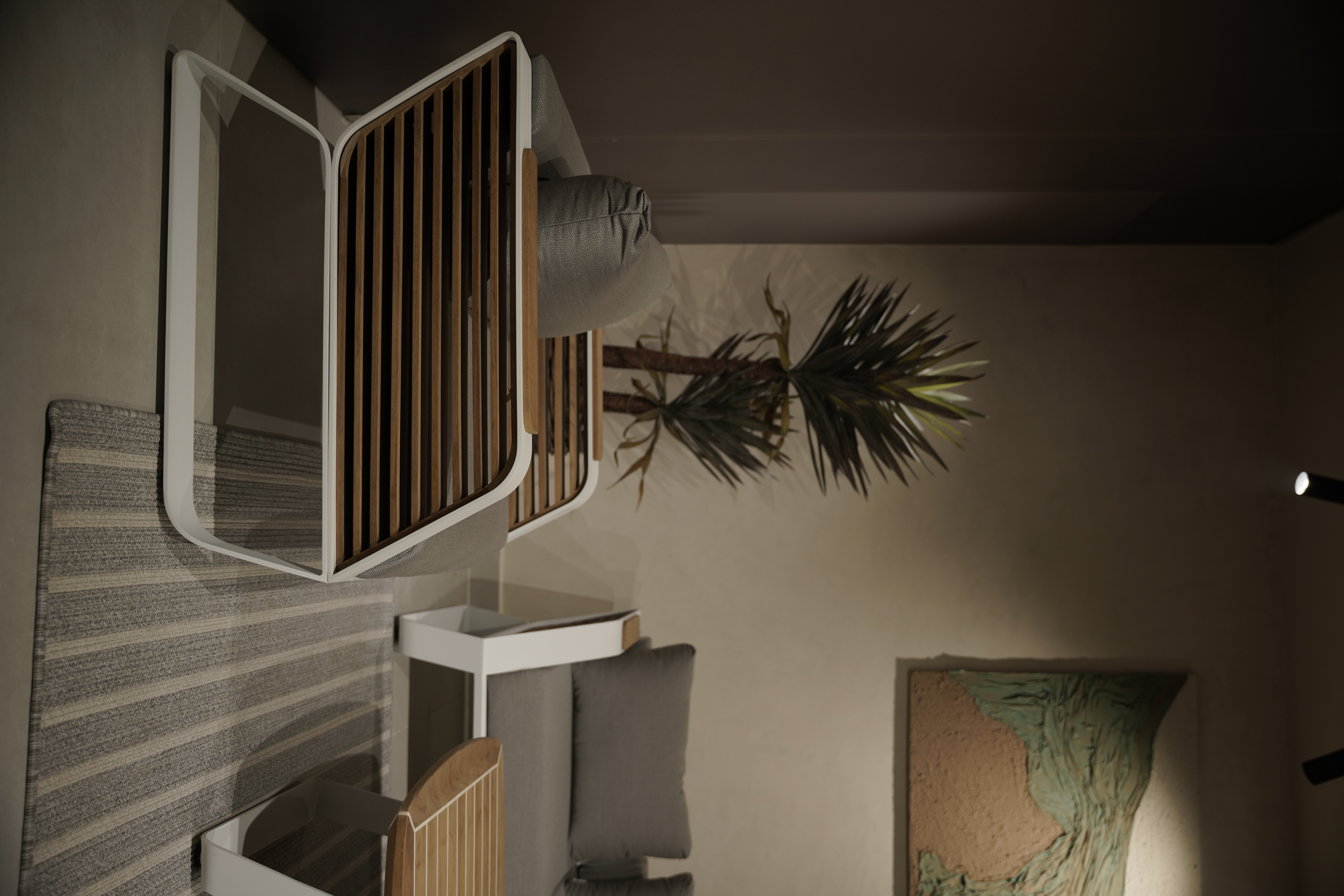 Nature-inspired outdoor seating area designed by Shruti Chadha with modern wooden chairs, neutral cushions, indoor plants, and a warm minimalist aesthetic in a Delhi residence.